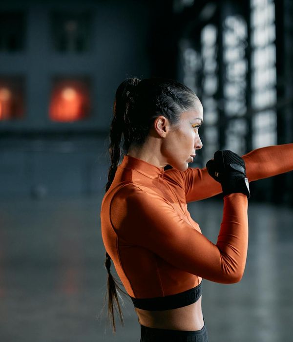 Woman performing a light cardio exercise in a calm studio.